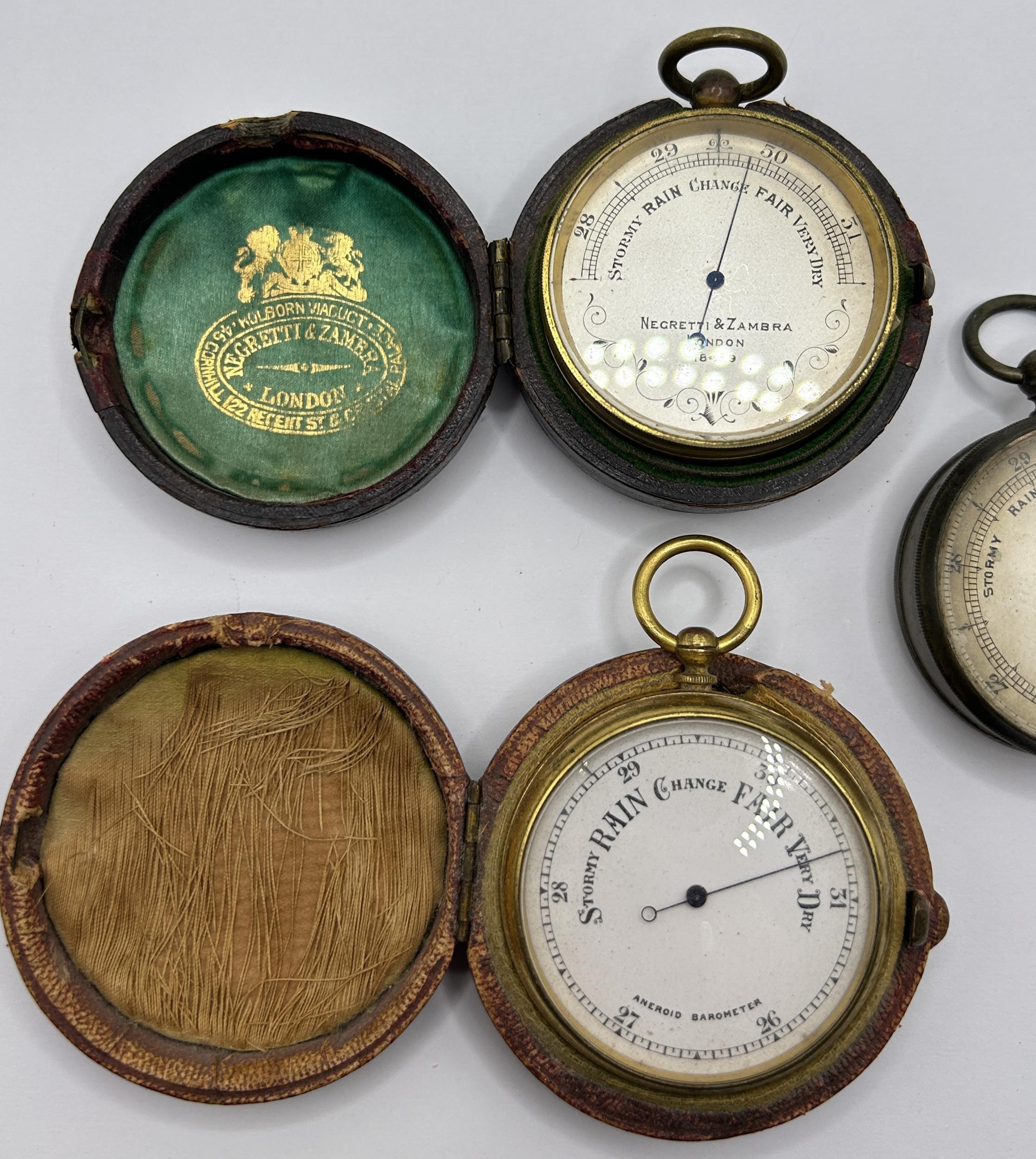 A pocket barometer, by Negretti & Zambra of London, No 18499, cased, another, cased, and another, - Image 2 of 5