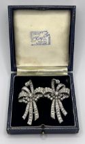 A diamond double clip bow brooch, set with baguette and brilliant cut diamonds, 7 cm wide, central