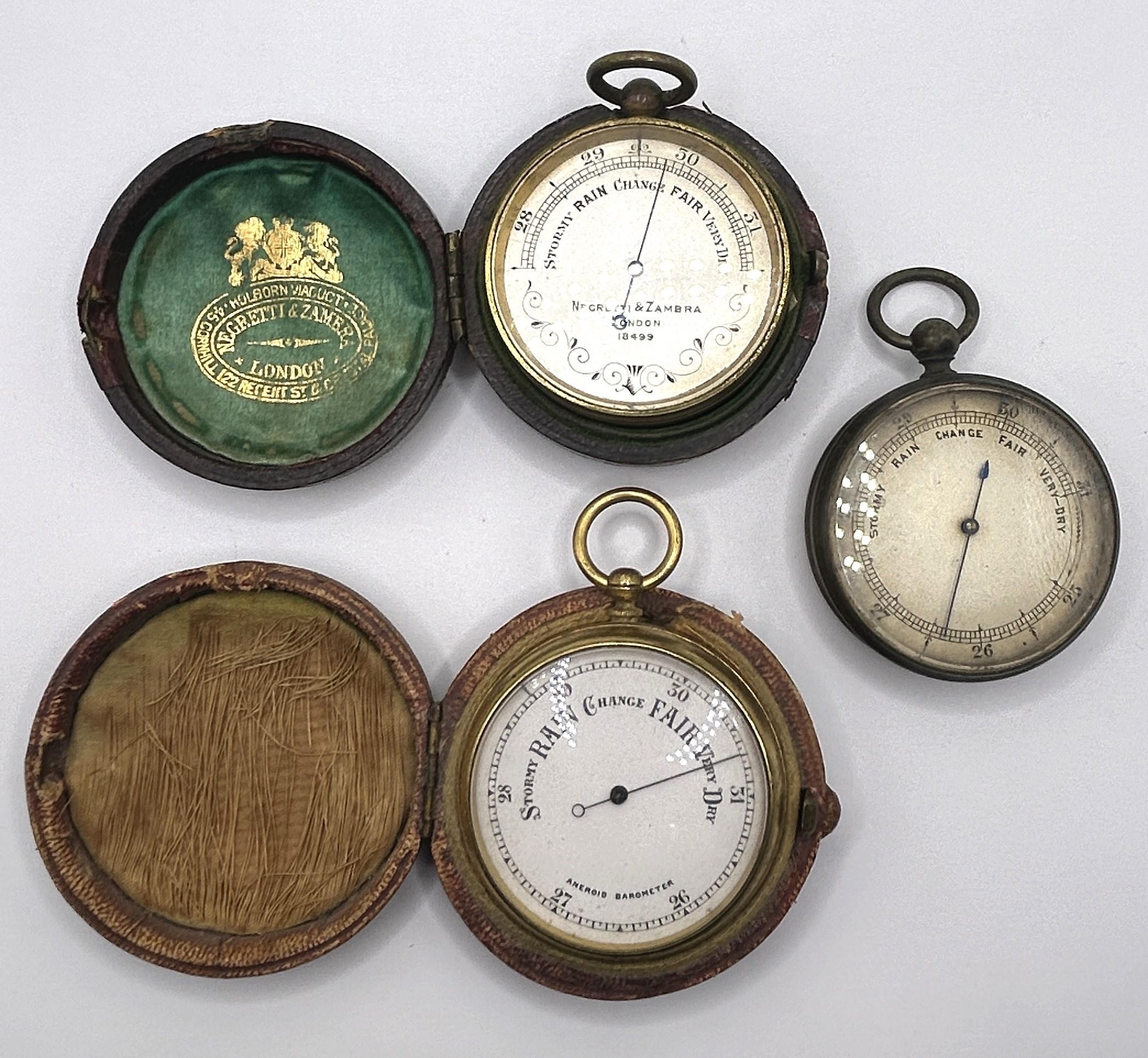 A pocket barometer, by Negretti & Zambra of London, No 18499, cased, another, cased, and another,