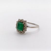 An 18ct white gold, emerald and diamond cluster ring, ring size Q 1/2 emerald cloudy, possibly