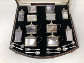 An extensive George V silver cruet set, comprising four pepperpots, four mustard pots, four salts,
