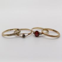 A 9ct gold, red stone and diamond ring (size M), a half eternity ring (size M 1/2), a wedding