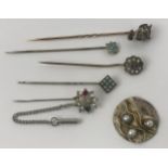 A stick pin, in the form of the devil, assorted stick pins, and a badge (6) Devil stick pin, diamond