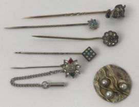 A stick pin, in the form of the devil, assorted stick pins, and a badge (6) Devil stick pin, diamond