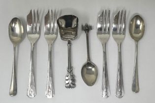 A Continental silver coloured metal sugar scoop, a set of four silver plated cake forks, two