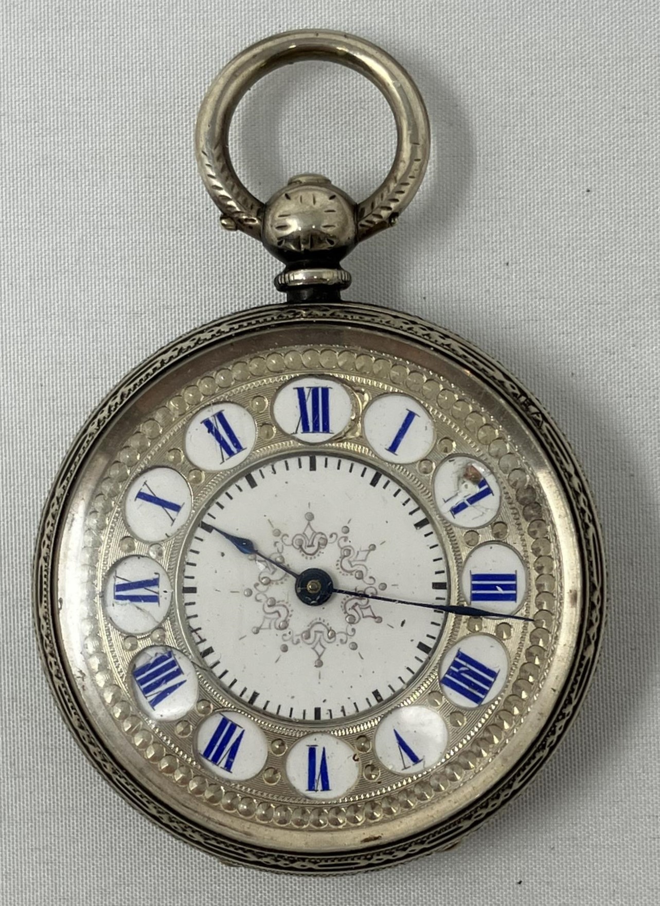 A Continental silver coloured metal fob watch, and a compact (2)