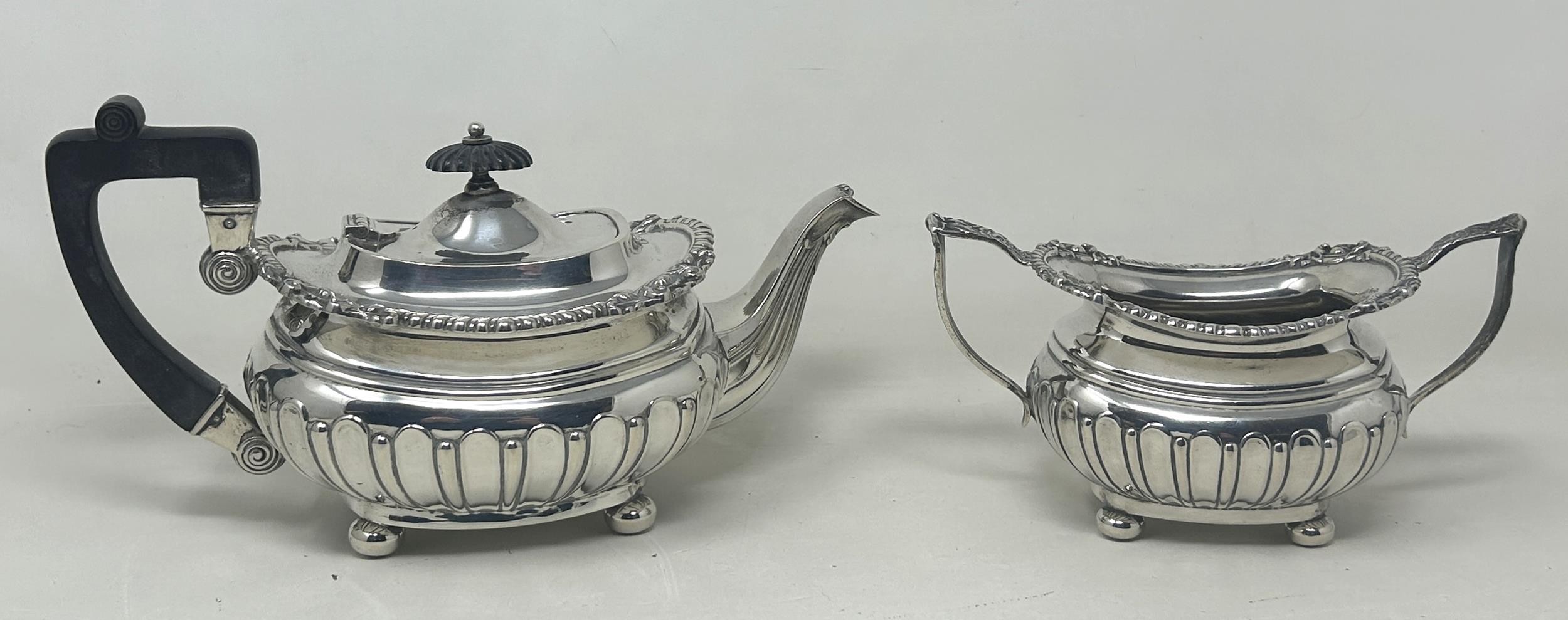 A George V silver bachelor teapot with an ebonised handle, and matching sugar bowl, London 1909, all