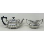 A George V silver bachelor teapot with an ebonised handle, and matching sugar bowl, London 1909, all