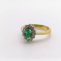 An 18ct gold, emerald and diamond ring, ring size N