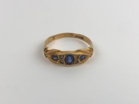 An 18ct gold red stone and diamond, ring size O, and an 18ct gold and blue stone ring, ring size L