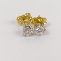 A pair of 18ct white and yellow gold diamond stud earrings 2.9 mm diameter aprox bright white