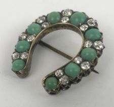 A turquoise and diamond brooch, in the form of a horsehoe Approx measurements: Length 28mm Width
