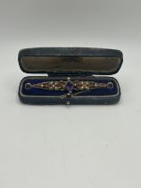 A late 19th/early 20th century amethyst and seed pearl bar brooch, in a vintage jewellery box, and a