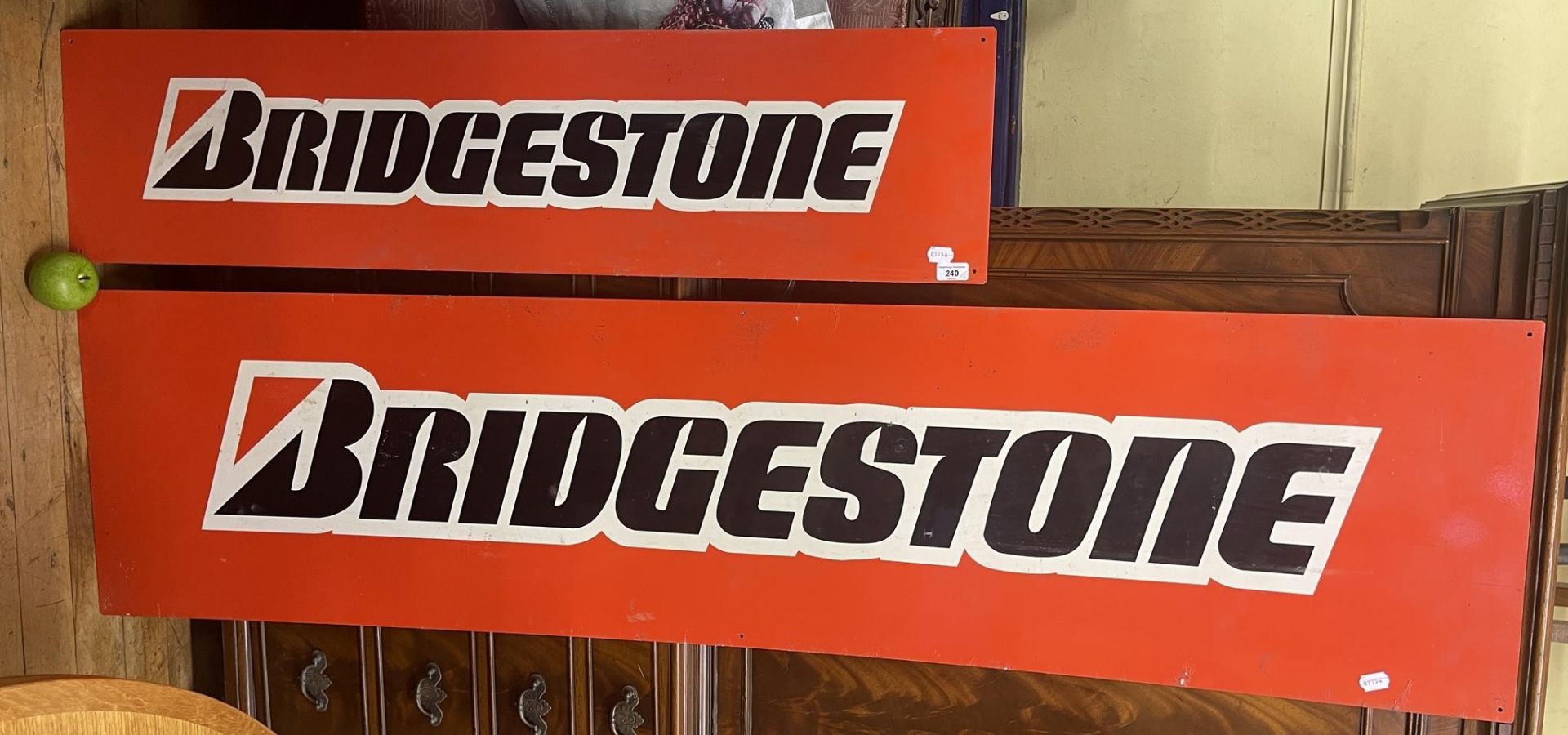 A metal sign, Bridgestone, 46 x 182 cm, and another. 30.5 x 122 cm (2)