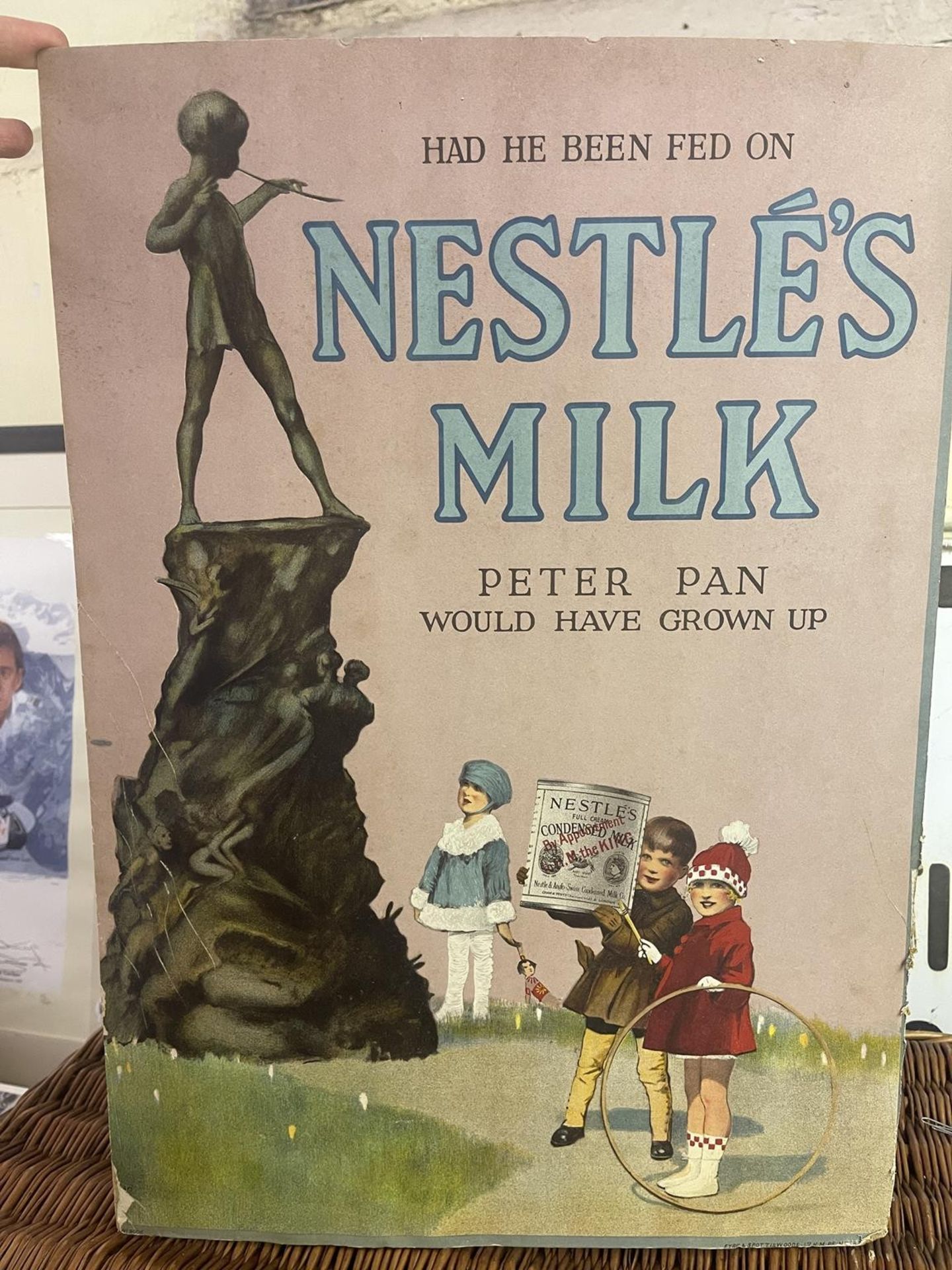 A Nestle's Milk advertising sign, 'Had he been fed Peter Pan would never have grown up' printed by