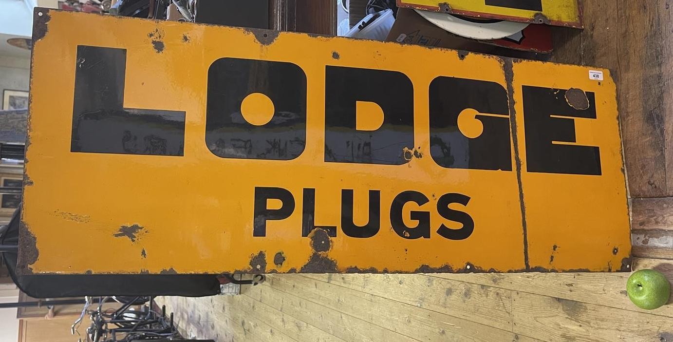 An enamel sign, Lodge Plugs, 45.5 x 122 cm Some loss, has been folded between the G and E