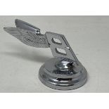 A rare Bentley desk paperweight, in the form of a backward winged Bentley mascot, inscribed H.R.