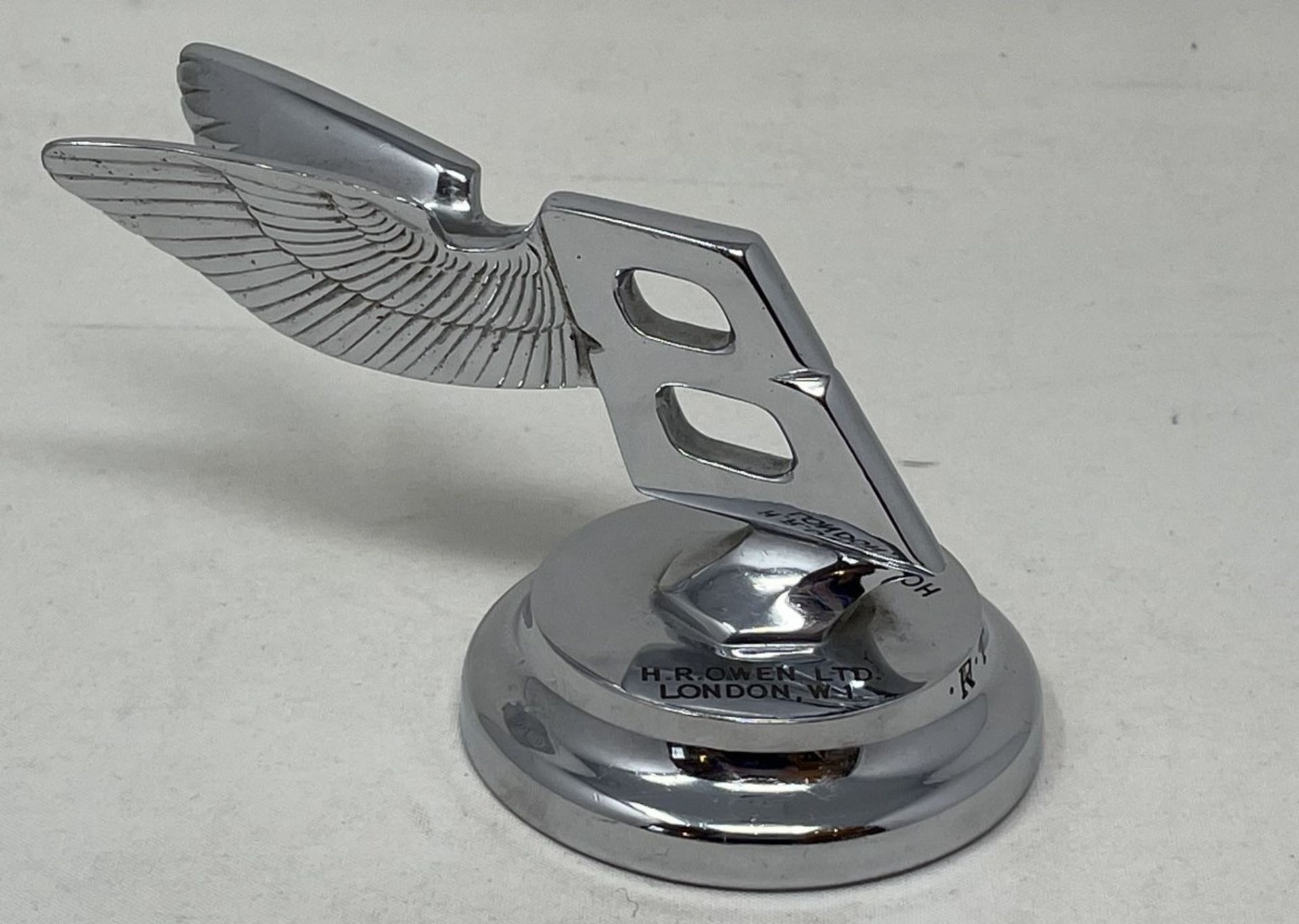 A rare Bentley desk paperweight, in the form of a backward winged Bentley mascot, inscribed H.R.