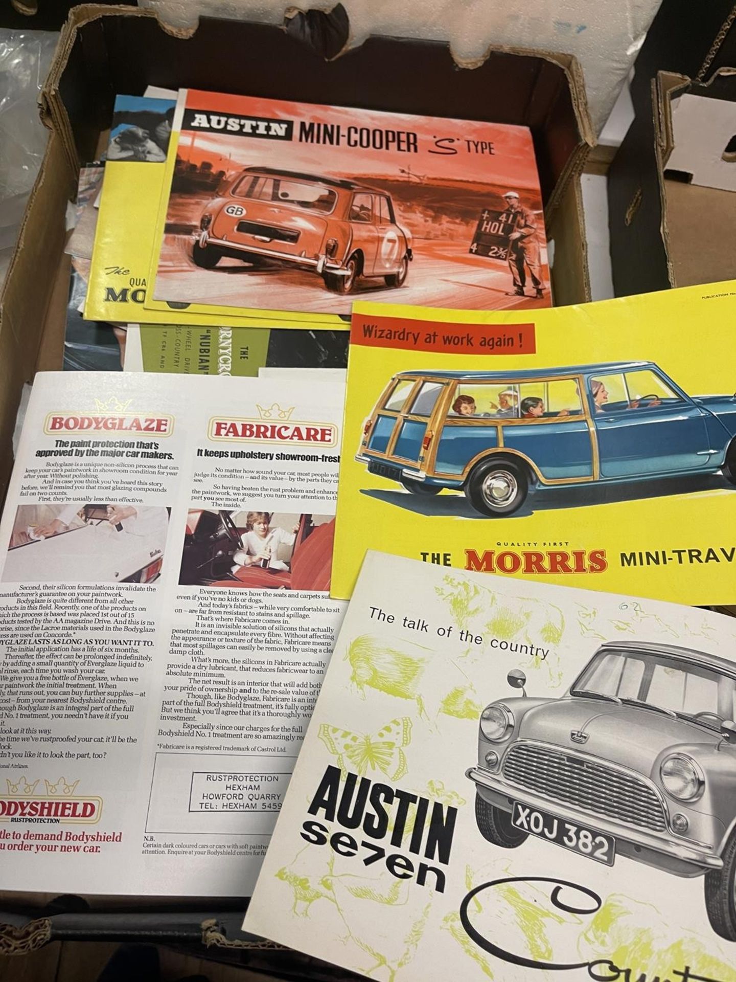 Assorted vehicle brochures, including Austin Mini-Cooper, S Type, Land-Rover, and Austin Se7en,