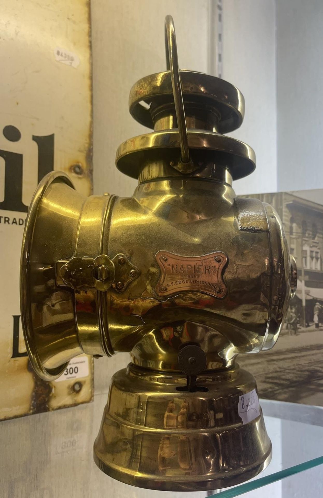 An S F E Napier (1907) vintage brass motor lamp, 34 cm high, and a photograph, of an American