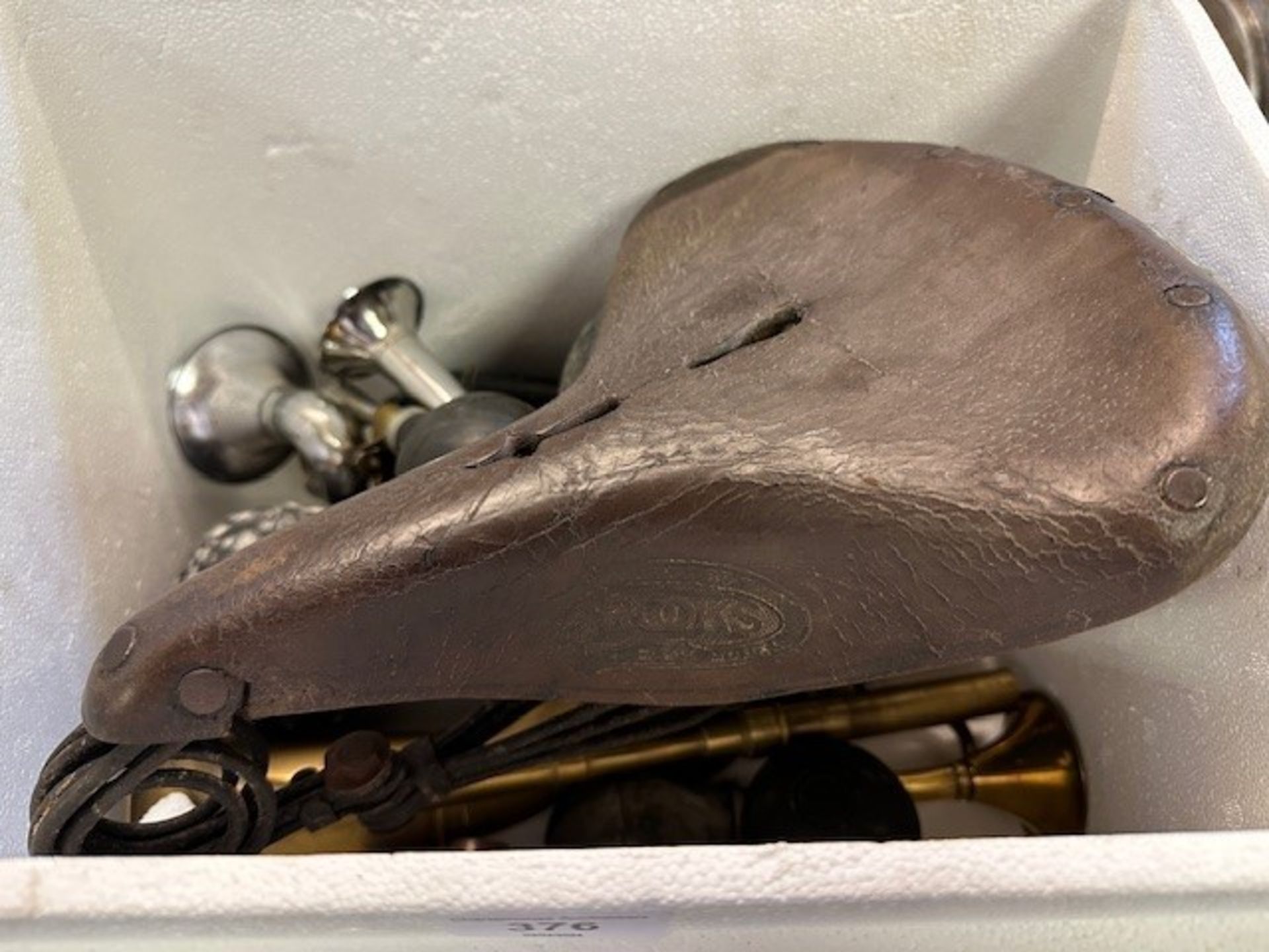 A Brooks vintage seat and assorted bulb horns (box)