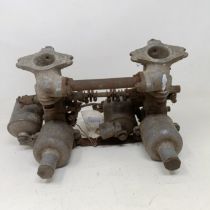 A pair of 1 1/4 inch SU carburettors, 6 7/8 inch between centres, on a manifold