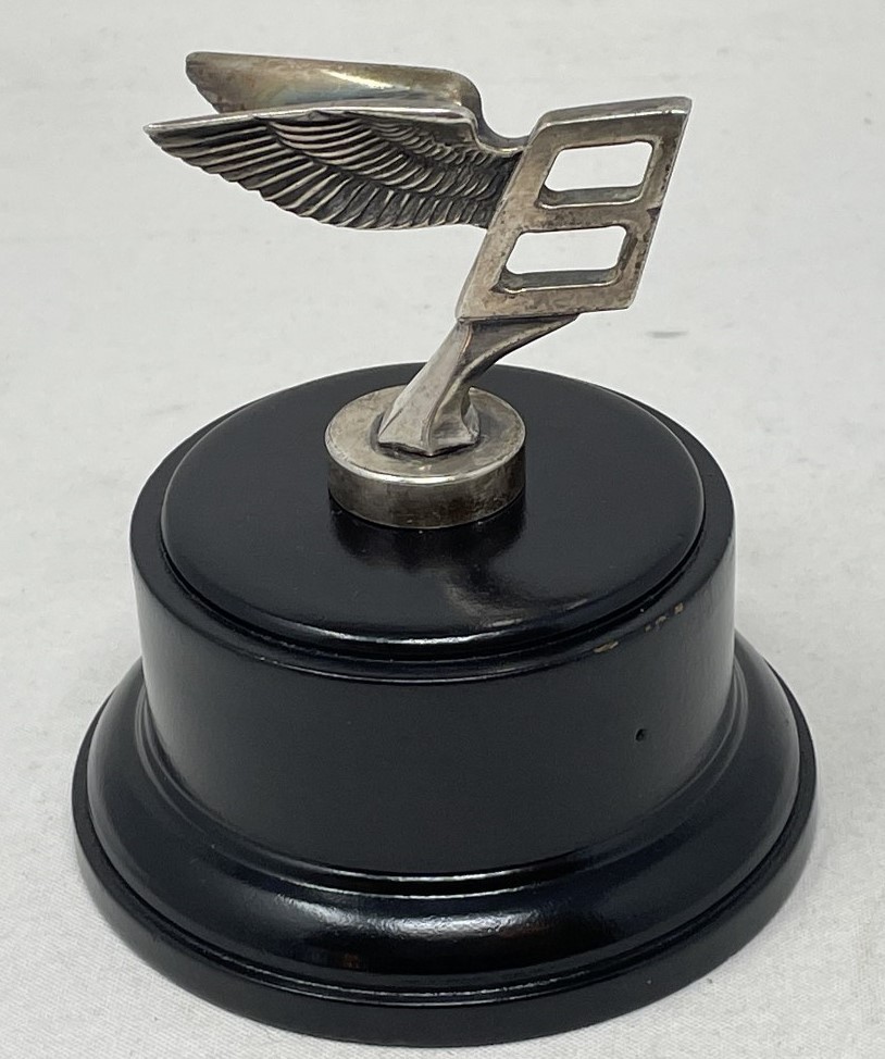 An unusual Bentley long service presentation mascot, formed as a miniature B mascot, mounted on