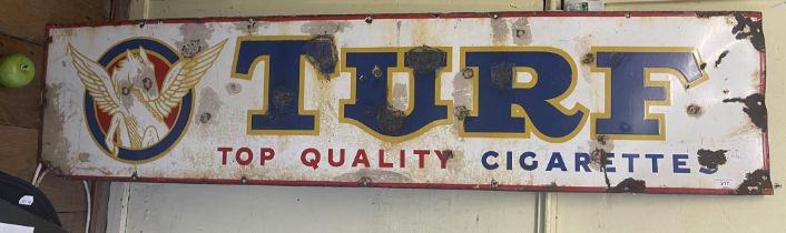 An enamel sign, Turf Top Quality Cigarettes, 38 x 163 cm Some staining, some areas touched up/