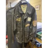 A Punch by Johann leather jacket, with various cloth badges, asssorted motorcycle related belt