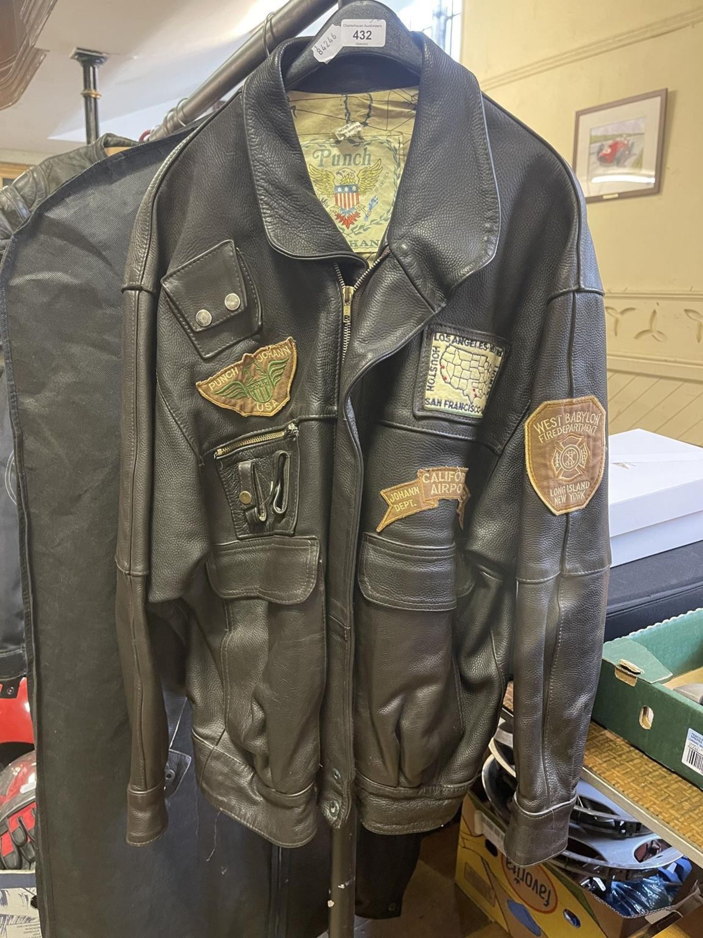 A Punch by Johann leather jacket, with various cloth badges, asssorted motorcycle related belt