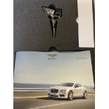 A Bentley wine bottle stopper, in the form of a winged B, boxed with paperwork, and Bentley