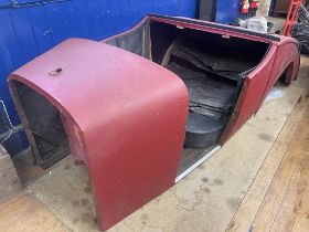 A vintage car body, a two seater with a dicky, with two doors, side screens and a tonneau From the