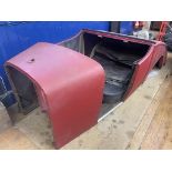A vintage car body, a two seater with a dicky, with two doors, side screens and a tonneau From the