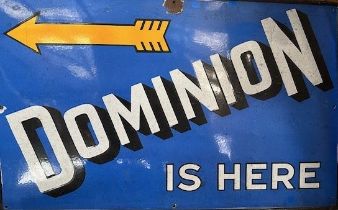 An enamel sign, Dominion Is Here, 76.5 x 122 cm Couple of chips around the fixing holes and to the