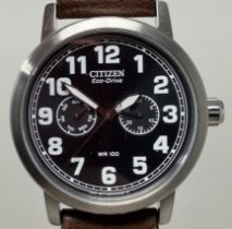 A gentleman's stainless steel Citizen Eco-Drive WR100 wristwatch, on a fabric strap, boxed, with