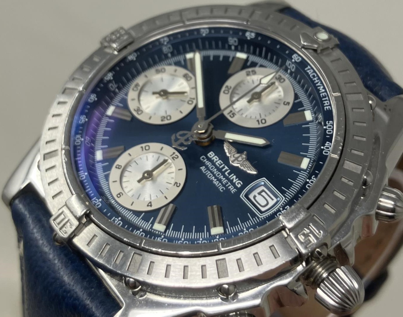 A gentleman's stainless steel Breitling Chronometre Automatic wristwatch, with a blue dial, on a