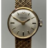 A ladies 9ct gold Garrard wirstwatch, on a 9ct gold strap, with a Garrard box 20g (all in)