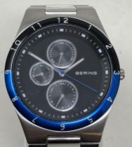 A gentleman's stainless steel Bering wristwatch 32339-702, in a glass case, with guarantee,