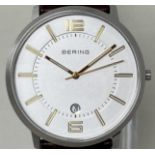 A gentleman's stainless steel Bering wristwatch 11139-501, on a leather strap, in a glass case, with