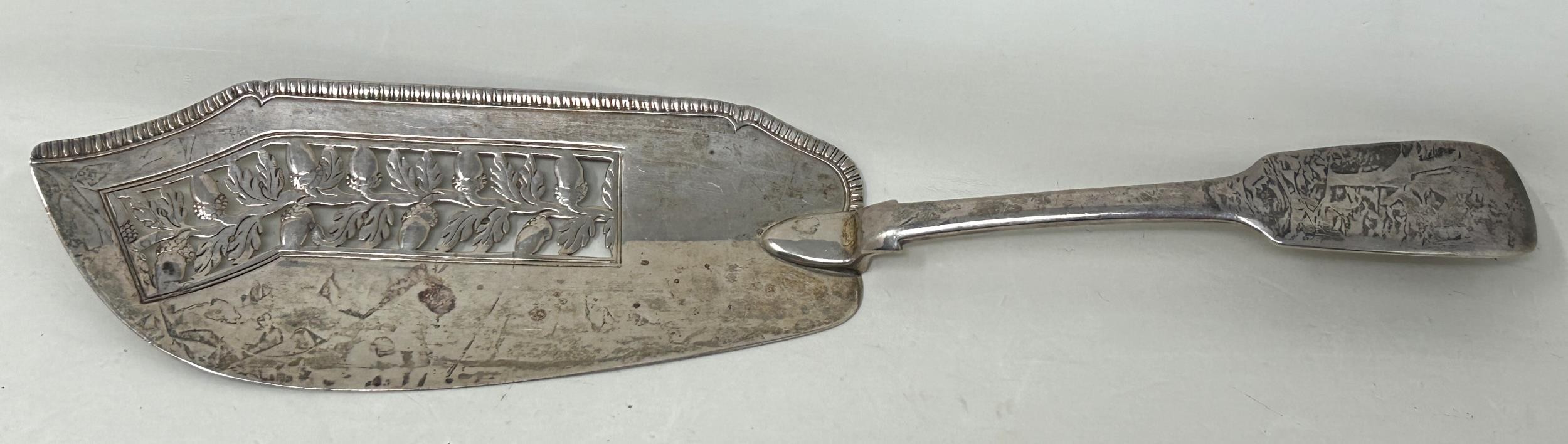 A George III silver fiddle pattern fish slice, with a pierced blade, decorated acorns, London