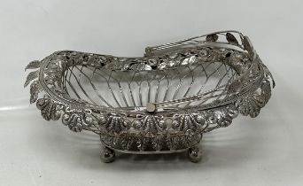 A silver coloured metal pierced swing handled basket 10.4 ozt