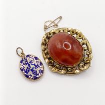 An early 20th century yellow coloured metal and amber coloured stone brooch, and a yellow metal