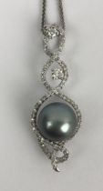 An 18ct white gold, pearl and diamond pendant, on a chain
