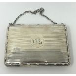 A George V silver purse, with a leather interior, Birmingham 1914, 4.2 ozt all in