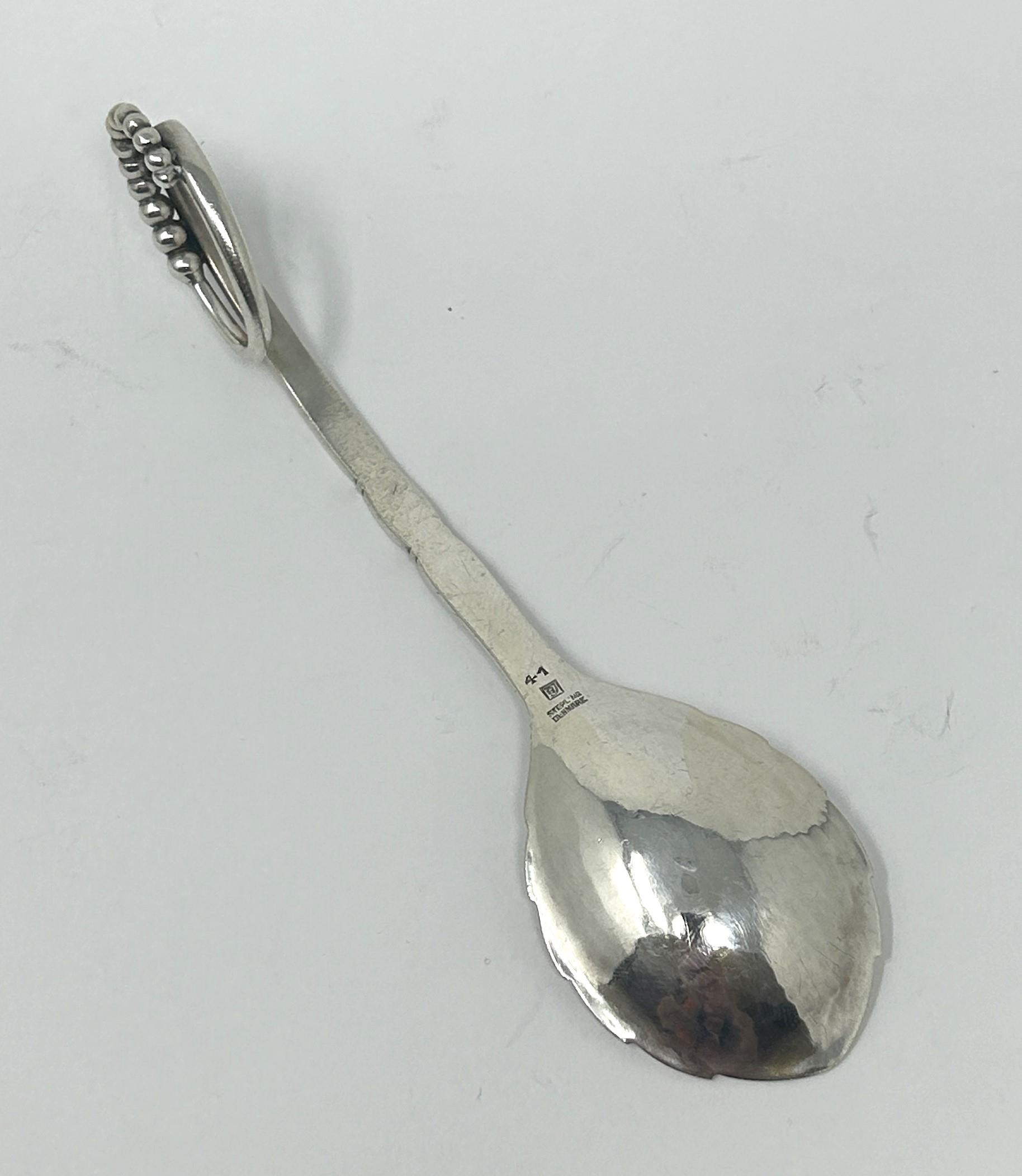 A Danish silver coloured metal spoon, by Georg Jensen, 32.4 g Approx. length: 15 cm - Image 4 of 5