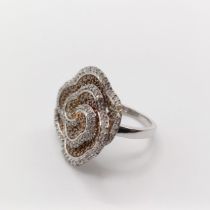 A large 9ct white gold and rose swirling floral diamond ring, size M 1/2