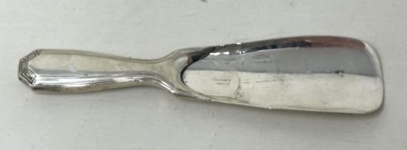 A Tiffany & Co sterling silver shoe horn, handle filled, all in 60 g