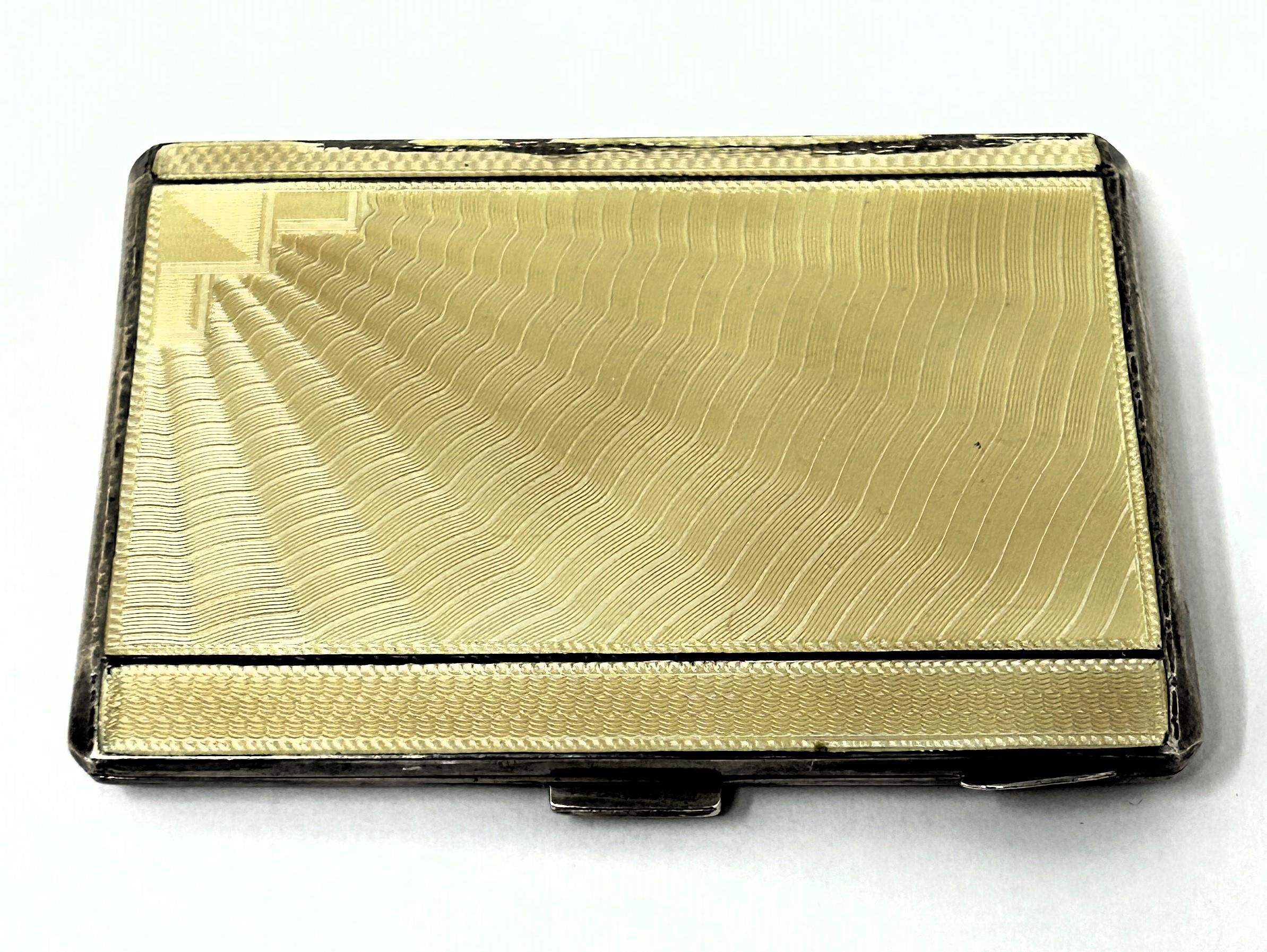 A George V silver and yellow enamel cigarette case, Birmingham 1932