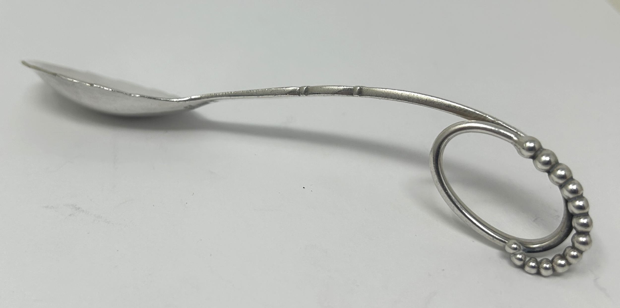 A Danish silver coloured metal spoon, by Georg Jensen, 32.4 g Approx. length: 15 cm - Image 3 of 5