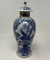 A Chinese blue and white vase and cover, decorated bird and foliage, four character mark to base, 30